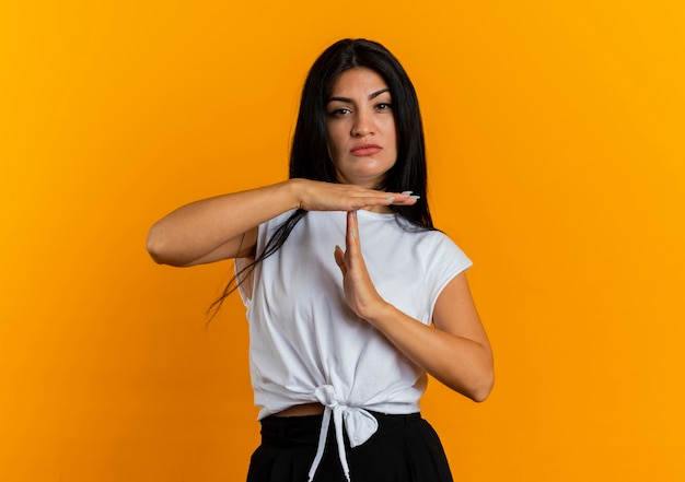 Confident young caucasian woman gesturing time out hand sign