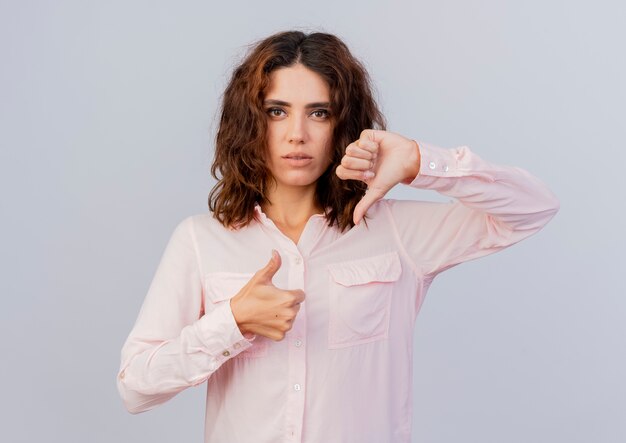 Confident young caucasian woman thumbs up and thumbs down