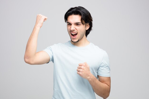 confident young handsome man looking at side showing yes gesture isolated on white background