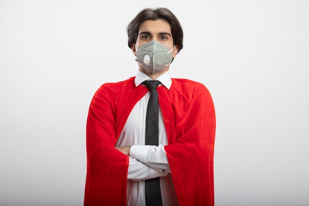 Free photo confident young superhero guy looking at camera wearing tie and medical mask