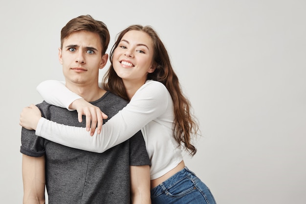 Confused boyfriend and happy girlfriend.