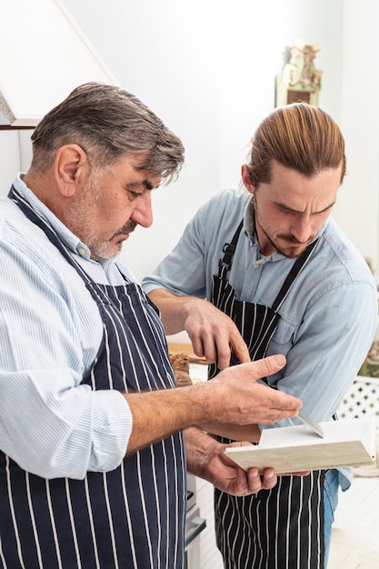 Confused father and son looking on a recipe