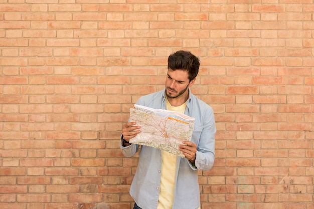 Confused man looking at map