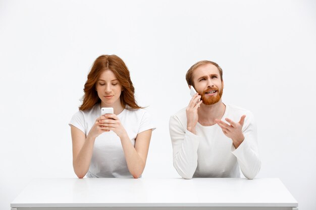 Confused man talk phone, girl smile at mobile display