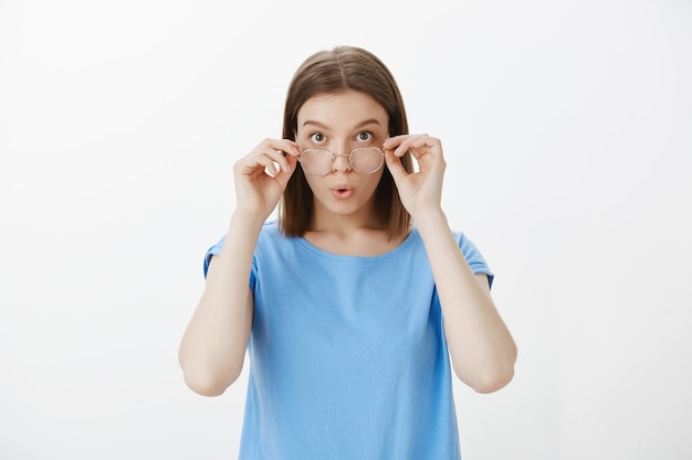 Free Photo confused and shocked woman take-off glasses, stare  amazed