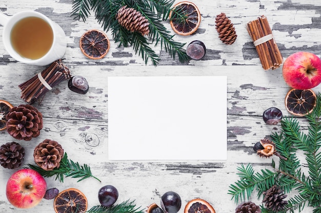 Free photo conifer branches and spices around paper sheet