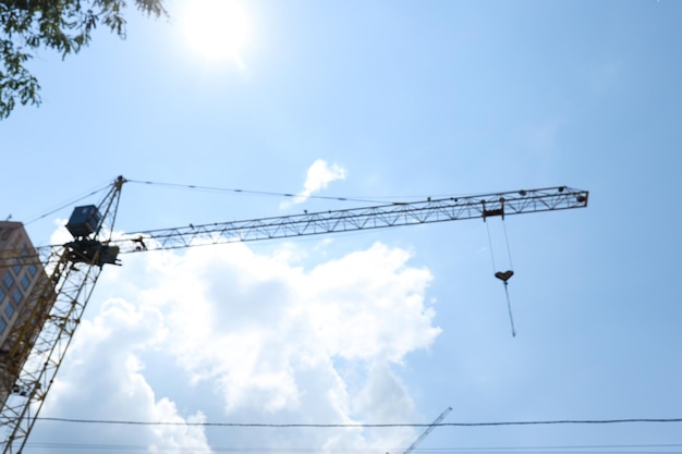 Free photo construction crane against blue sky in sunny day