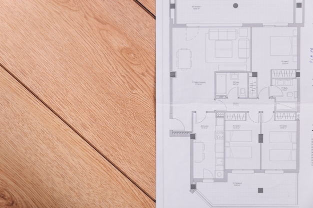 Construction plan on wooden floor