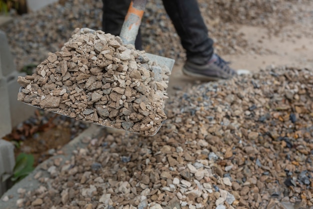 Construction technicians are mixing cement, stone, sand for construction.