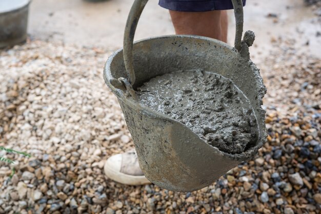 Construction technicians are mixing cement, stone, sand for construction.