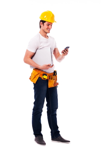 Construction worker checking something on the mobile phone