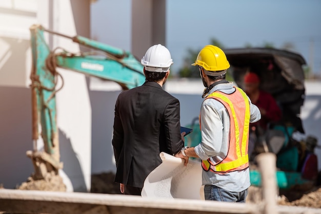 Construction worker and engineer working together on construction site