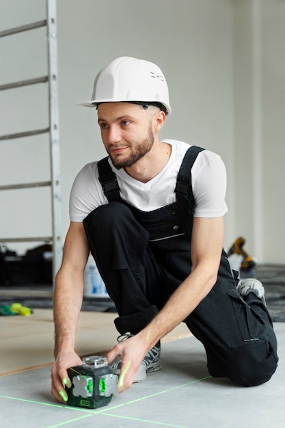 Construction worker holding tool full shot