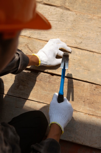 Free photo construction worker using hammer at job site