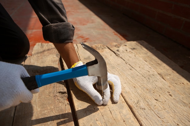 Construction worker using hammer at job site