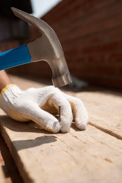 Construction worker using hammer at job site