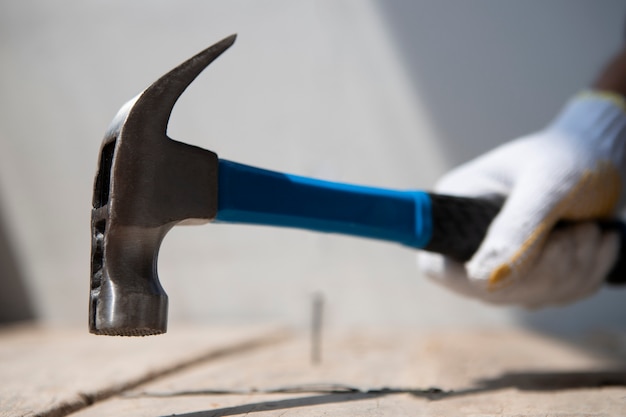 Construction worker using hammer at job site