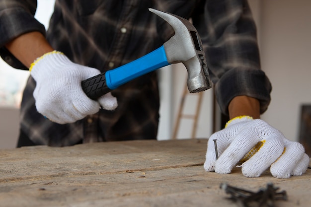 Free photo construction worker using hammer at job site