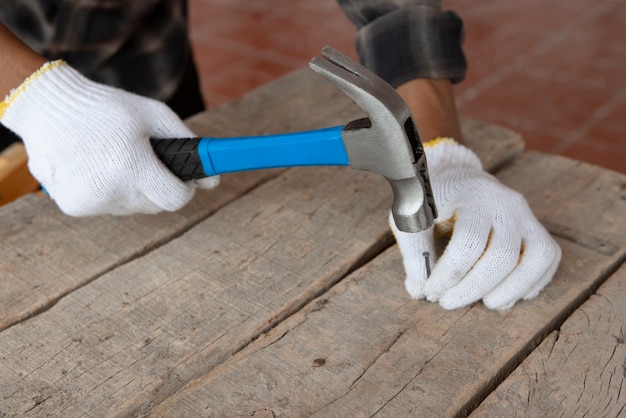 Free Photo construction worker using hammer at job site