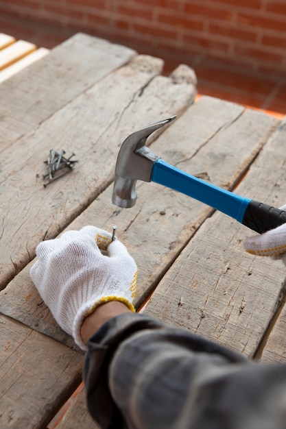 Free photo construction worker using hammer at job site