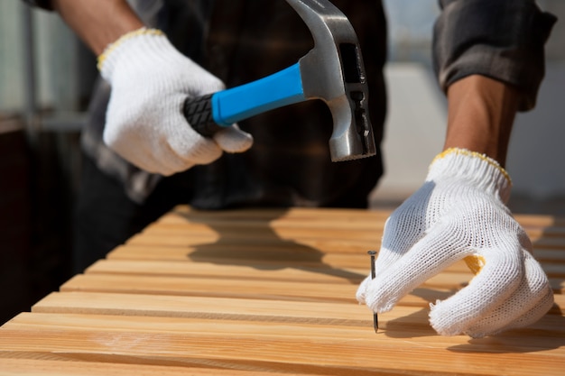 Free photo construction worker using hammer at job site