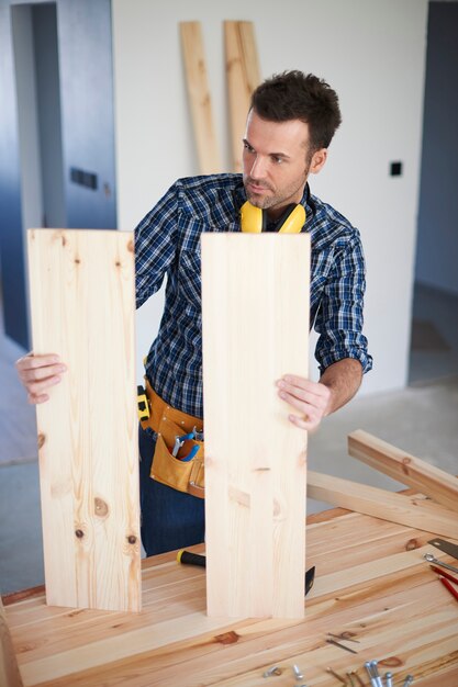 Construction worker with wooden boards