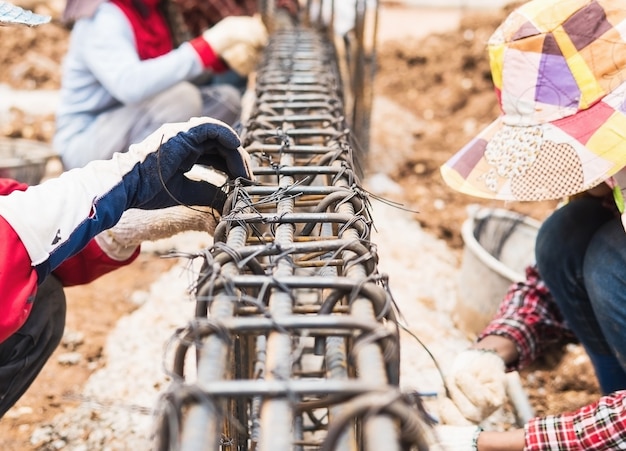 Free photo construction workers are installing steel rods in reinforced concrete beam