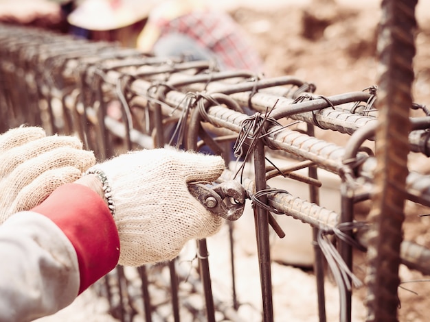 Free photo construction workers are installing steel rods in reinforced concrete beam