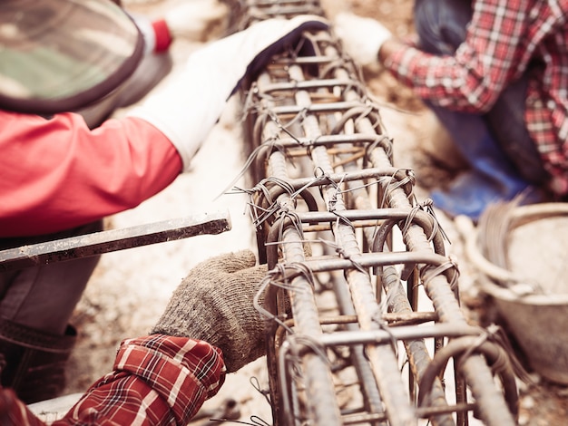 Free Photo construction workers are installing steel rods in reinforced concrete beam