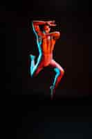 Free photo contemporary male ballet dancer performing in spotlight