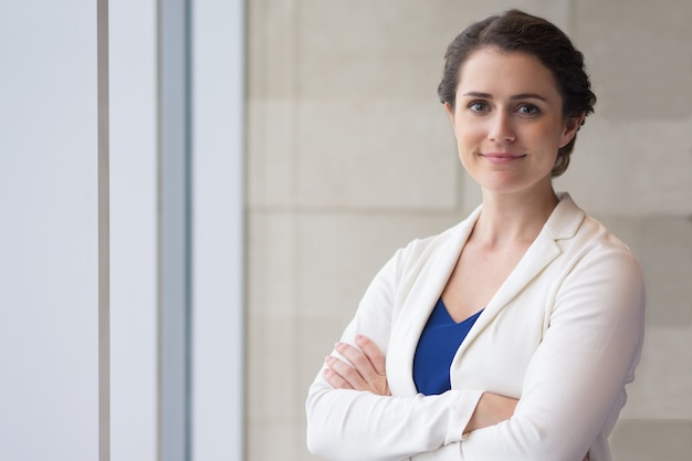 Content Beautiful Businesswoman Standing at Window