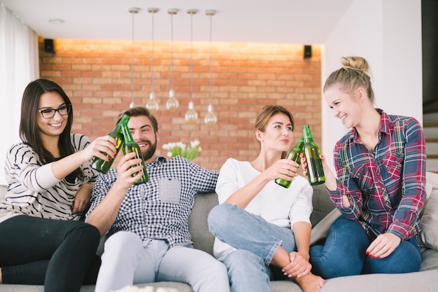 Free photo content friends cheering with beer having fun