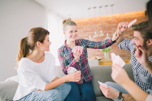 Free photo content friends having fun playing cards