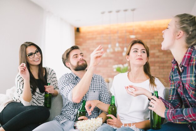 Content friends playing and drinking beer