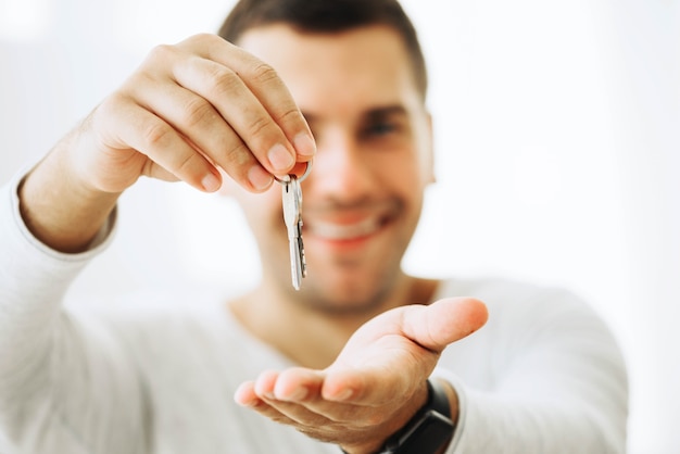 Free photo content man holding new keys