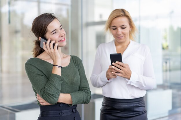 Content office colleagues using phones