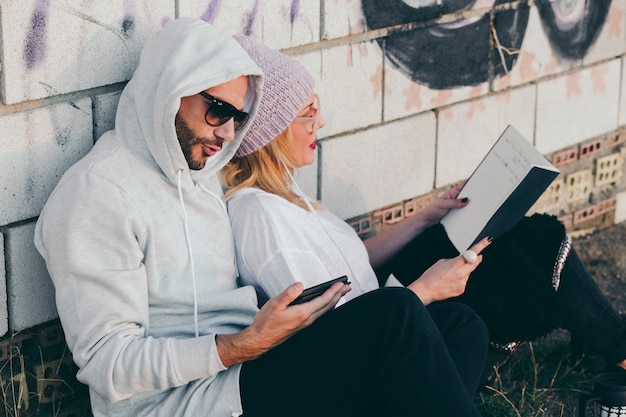 Free photo content people lounging with book and gadget