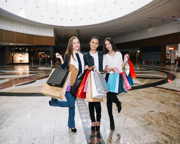 Content stylish women in shopping mall