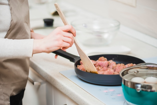 Free Photo cook frying meat at kitchen