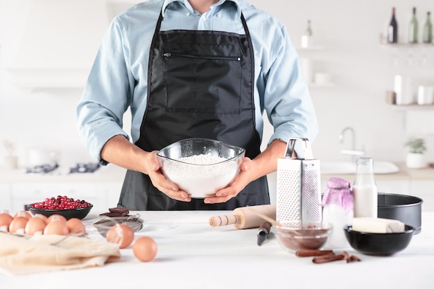 Free photo a cook with eggs on rustic kitchen against the of men's hands