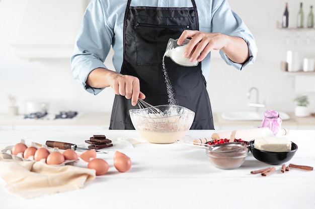 Free photo cook with eggs on a rustic kitchen