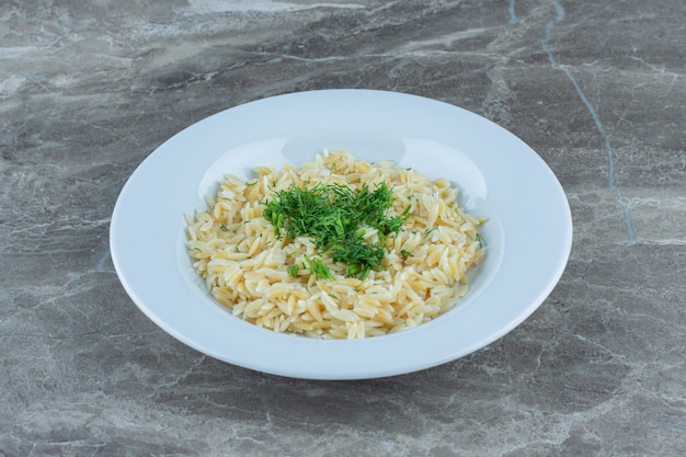 Cooked basmati rice in a plate , on the marble table. 