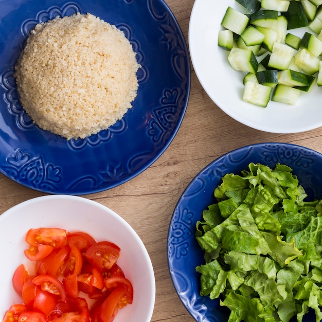 Free Photo cooked rice with different cut vegetables in bowls