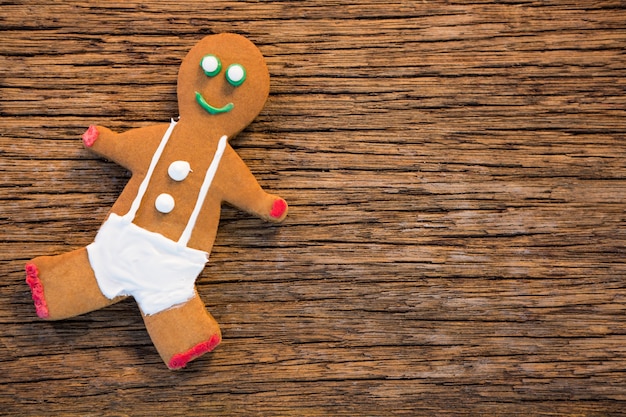 Free photo cookie man on a wooden table