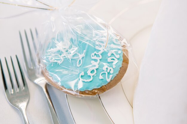 Cookie with blue glaze served on white plate