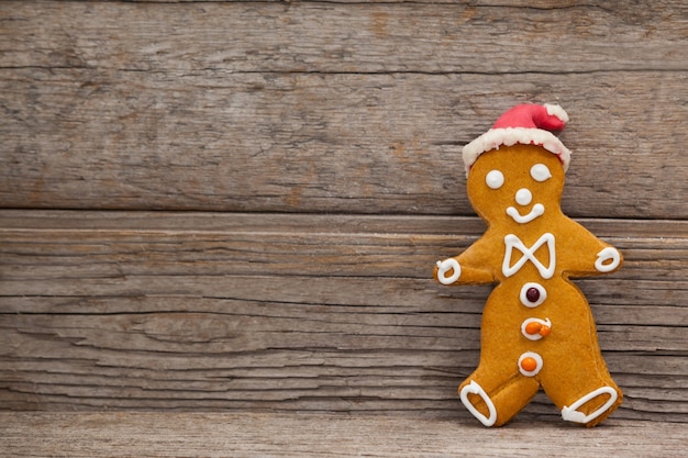 Free Photo cookie with person shape on a wooden table