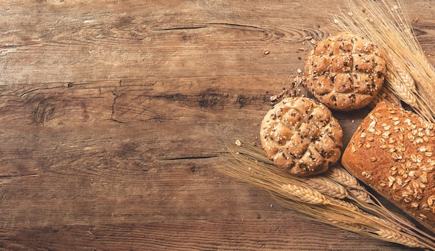 Cookies, bread, and wheat on table