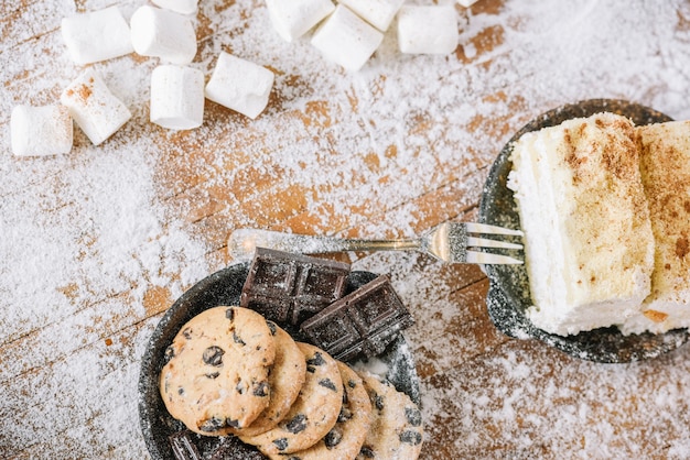 Cookies and chocolate with cake on decorated table