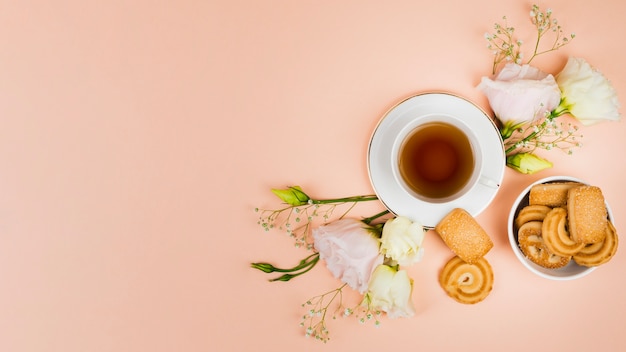 Cookies and flowers in flat lay