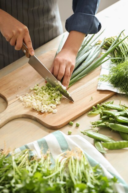 Cooking. Chef is cutting greens in the kitchen